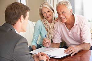 a financial consultant speaking with a retired couple to inform them about their 401(k) as well as the 401(k) withdrawal penalty and how to avoid it