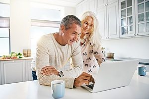 an elderly couple who are filing their 401(k) forms with the IRS to make sure they do not have a 401(k) withdrawal penalty