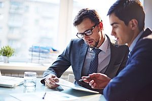 two coworkers deciding on their 401(k) contribution plans and how they will move forward with saving for retirement