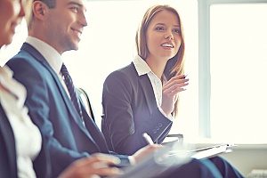 a business woman in a meeting about profit sharing plans with a retirement plans consultant asking about how her plan works