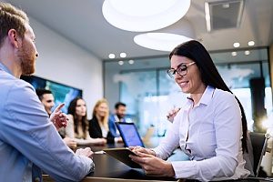 a business woman who is speaking with financial consultants about a tax deferred annuity plan she would like to sign up for