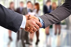 a handshake between a business owner and the owner of a financial consultants firm after discussing retirement plans for small businesses