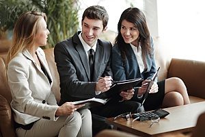 three business executives holding an employee retirement plan management meeting