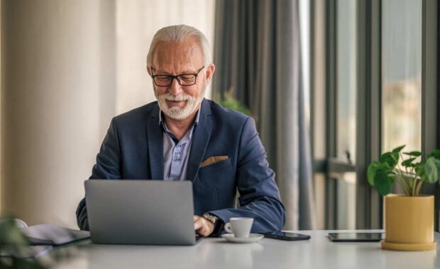 professional man scrolling through their laptop